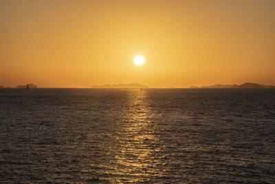 Scenic view of sea against orange sky