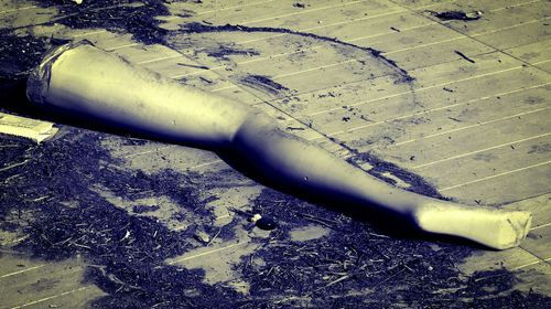 Close-up of man's hand on sand