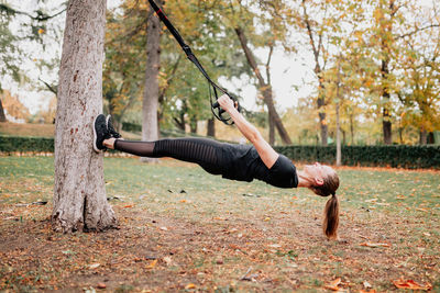 Full length of woman exercising in park