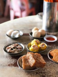 Sweet food in bowls on table