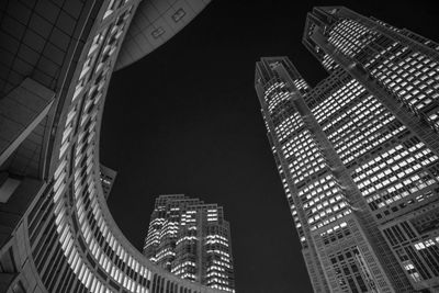 Low angle view of modern buildings in city at night