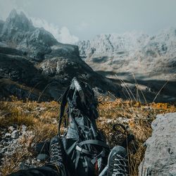 Low section of person with backpack on mountains during winter