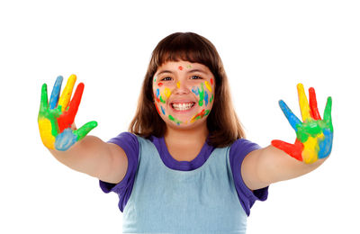 Portrait of smiling girl holding multi colored background