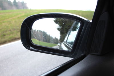 Reflection of car on side-view mirror