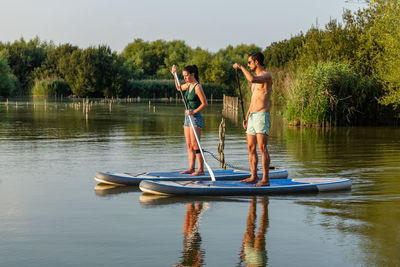 Side view of man jumping in lake