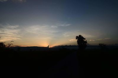 Silhouette landscape against sky at sunset