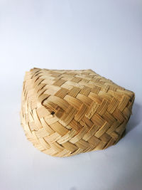 Close-up of wicker basket on white background