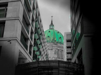 Low angle view of buildings against sky in city