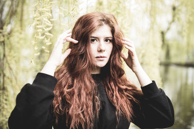 Beautiful redhead young woman outdoor portrait. spring time