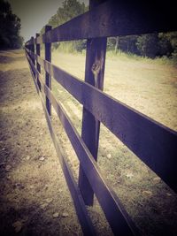 Shadow of fence on field