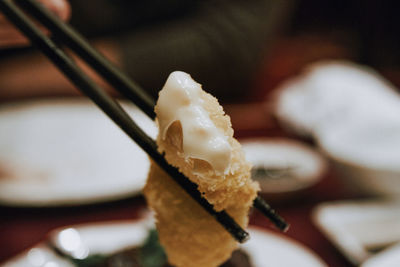 Close-up of chopsticks with food at table