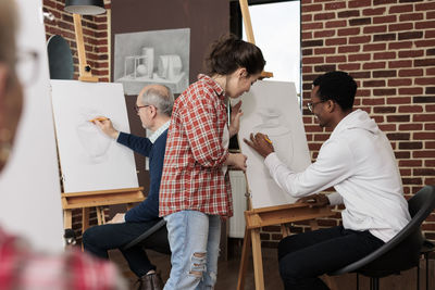 Side view of business colleagues working in office