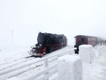 Snow covered train against sky