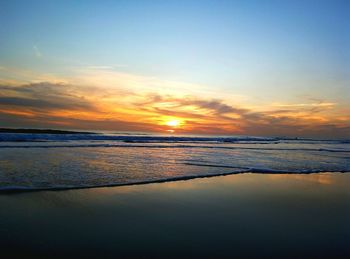 Scenic view of beach against sky during sunset