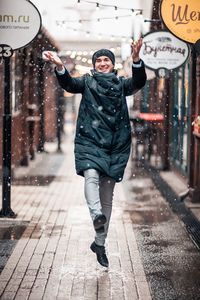 Full length portrait of young man in rain