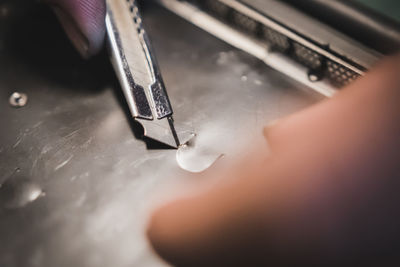 Close-up of human hand on metal