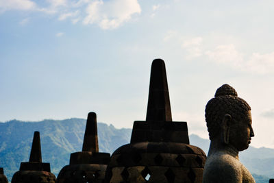 Statue of borobudur temple, central java against blue sky before sunset