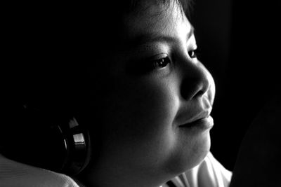 Close-up of boy listening to headphones