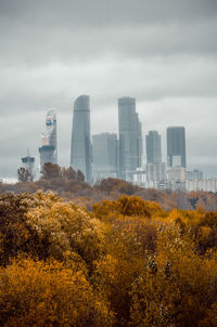 View of cityscape against sky during autumn