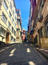 Street amidst buildings in city against sky