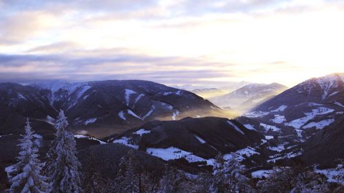 Scenic view of snow covered mountains against sky