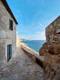 View of building by sea against sky