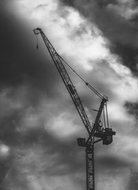 Low angle view of crane against sky