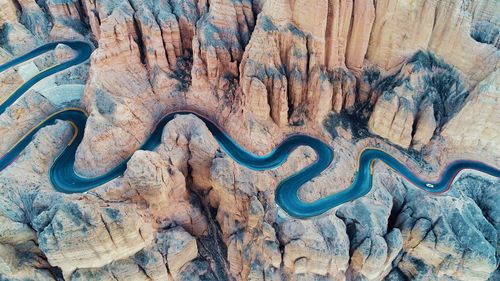 Aerial view of winding road amidst rock formation