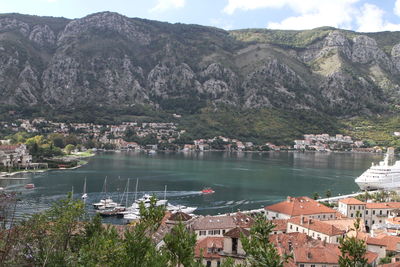 High angle view of lake by buildings and mountains