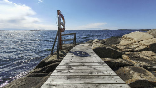 Pier over sea against sky