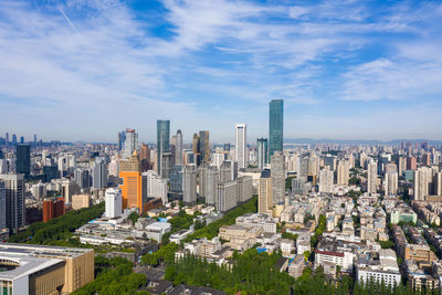 Aerial view of modern buildings in city against sky