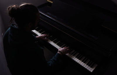 High angle view of man playing piano at home