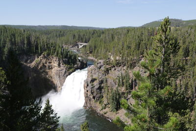 Scenic view of waterfall against sky