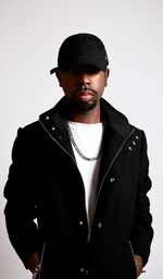 Portrait of young man standing against white background