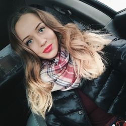 Portrait of beautiful woman sitting in car