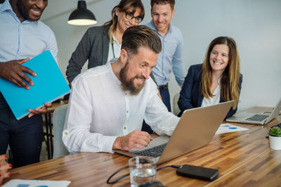 Group of colleagues working on project in office