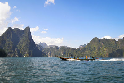 Scenic view of sea and mountains against sky