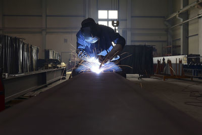 Welder at work in factory