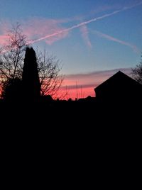 Buildings against sky at sunset