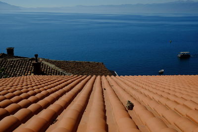 High angle view of roof by sea against sky