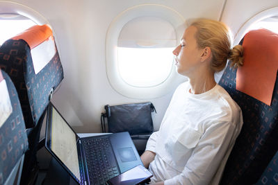 Businesswoman sleeping while sitting in plane