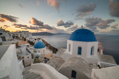 Panoramic view of buildings and sea against sky during sunset