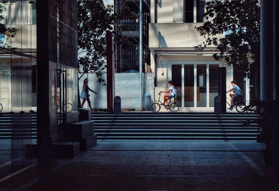 PEOPLE WALKING ON STREET AMIDST BUILDINGS