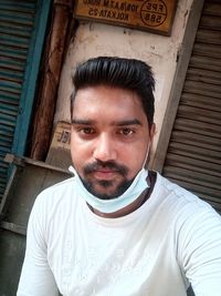 Portrait of young man standing outdoors