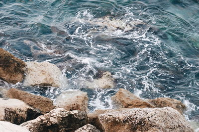 High angle view of rocks in sea