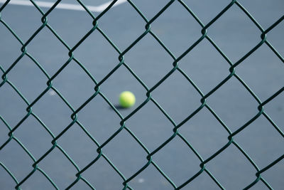 Full frame shot of city seen through chainlink fence