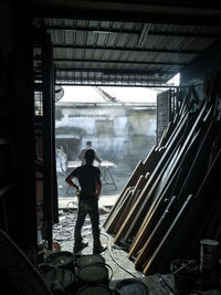 Rear view of man standing in building