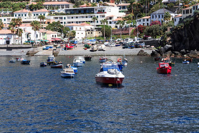 Boats moored at harbor