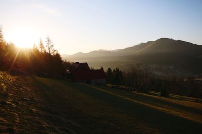 Scenic view of landscape and mountains against sky during sunset