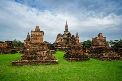 Old temple building against cloudy sky